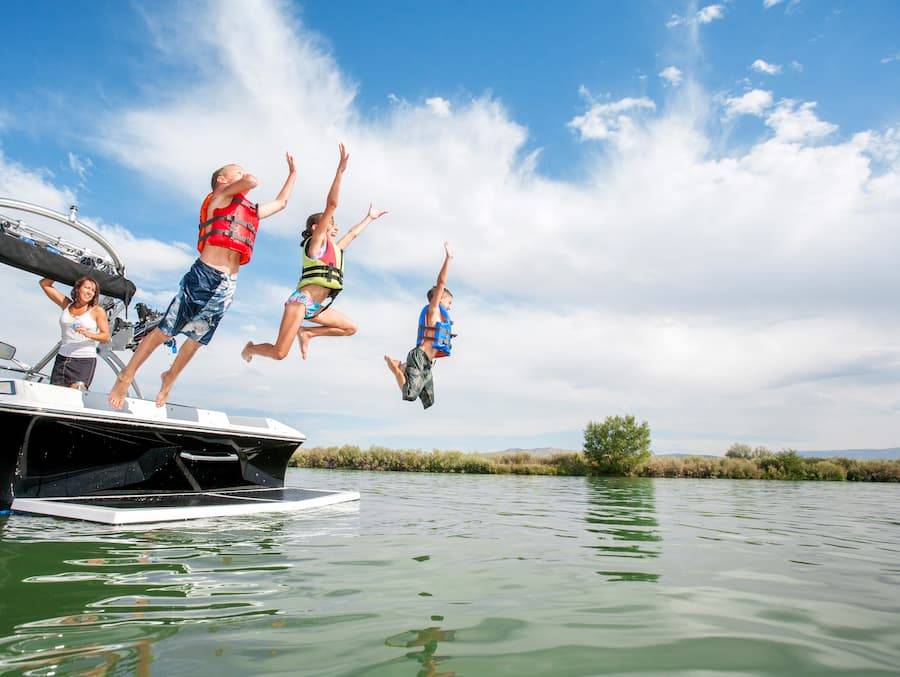 Kids Jumping Into Lake From Boat 1
